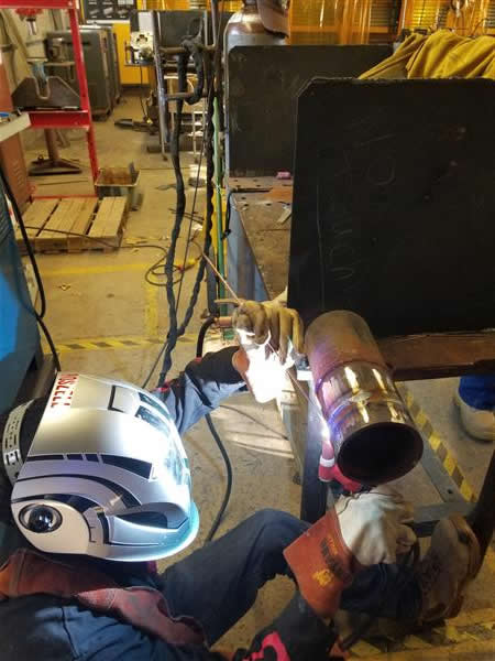 Student practicing welding in the classroom