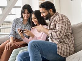  family on couch looking at cell phone